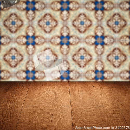Image of Wood table top and blur vintage ceramic tile pattern wall