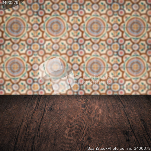 Image of Wood table top and blur vintage ceramic tile pattern wall