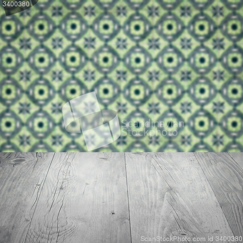 Image of Wood table top and blur vintage ceramic tile pattern wall