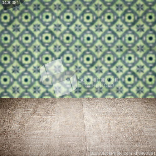 Image of Wood table top and blur vintage ceramic tile pattern wall