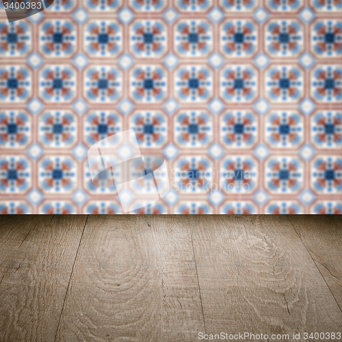Image of Wood table top and blur vintage ceramic tile pattern wall