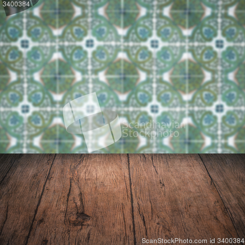 Image of Wood table top and blur vintage ceramic tile pattern wall