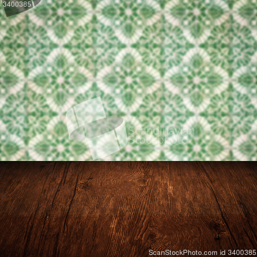 Image of Wood table top and blur vintage ceramic tile pattern wall