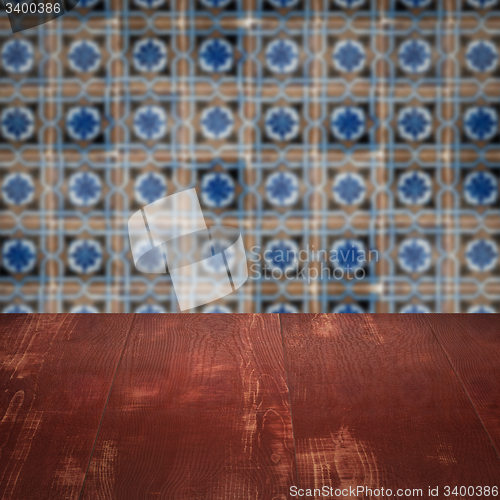 Image of Wood table top and blur vintage ceramic tile pattern wall