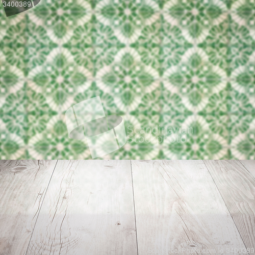 Image of Wood table top and blur vintage ceramic tile pattern wall