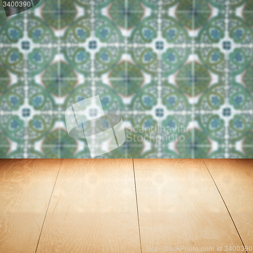 Image of Wood table top and blur vintage ceramic tile pattern wall