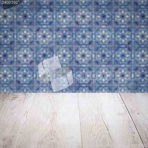 Image of Wood table top and blur vintage ceramic tile pattern wall