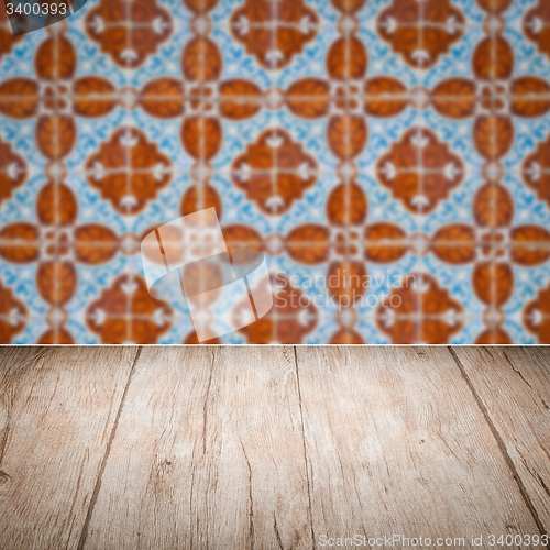 Image of Wood table top and blur vintage ceramic tile pattern wall