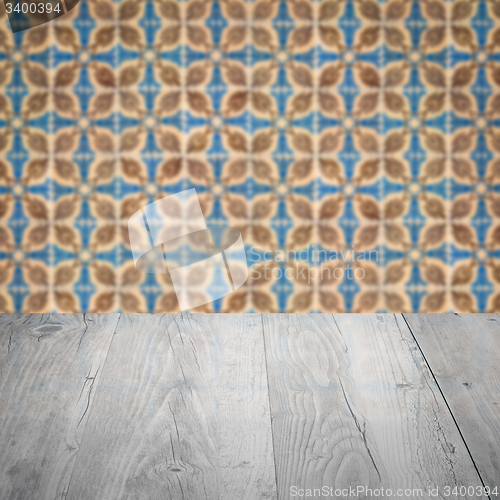 Image of Wood table top and blur vintage ceramic tile pattern wall