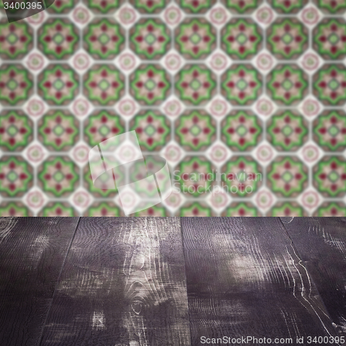 Image of Wood table top and blur vintage ceramic tile pattern wall