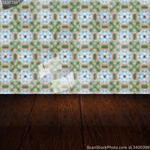 Image of Wood table top and blur vintage ceramic tile pattern wall