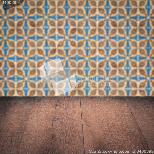 Image of Wood table top and blur vintage ceramic tile pattern wall