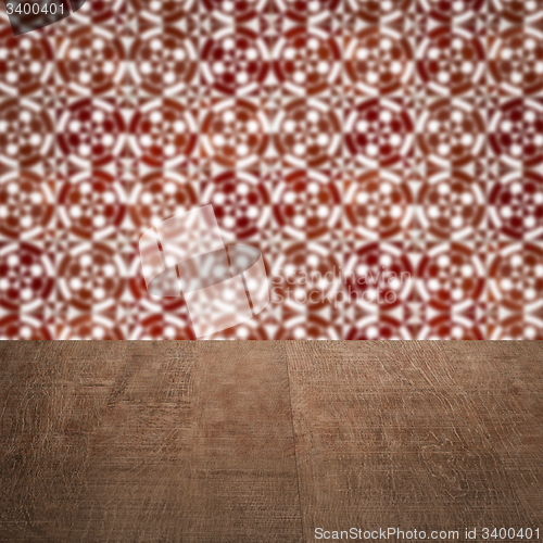Image of Wood table top and blur vintage ceramic tile pattern wall
