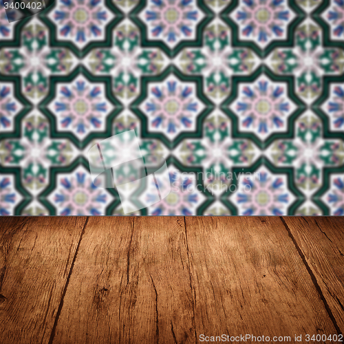 Image of Wood table top and blur vintage ceramic tile pattern wall