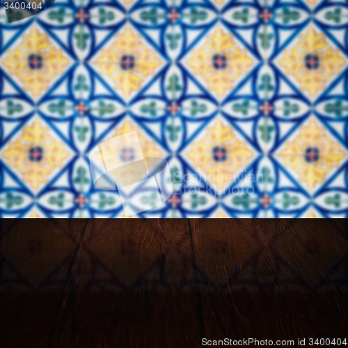 Image of Wood table top and blur vintage ceramic tile pattern wall