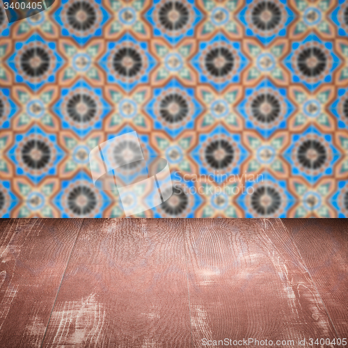 Image of Wood table top and blur vintage ceramic tile pattern wall