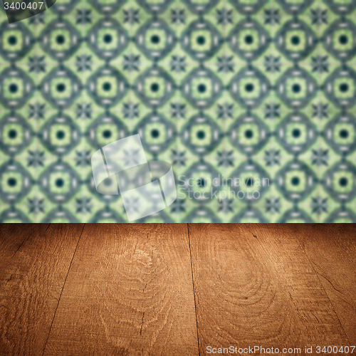 Image of Wood table top and blur vintage ceramic tile pattern wall