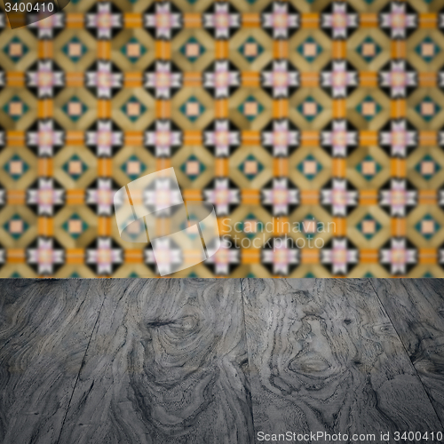 Image of Wood table top and blur vintage ceramic tile pattern wall