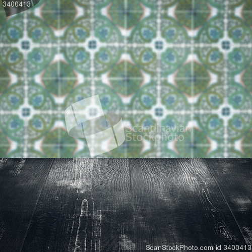 Image of Wood table top and blur vintage ceramic tile pattern wall