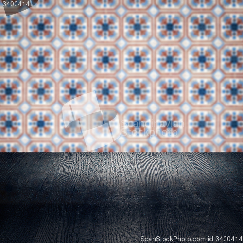 Image of Wood table top and blur vintage ceramic tile pattern wall