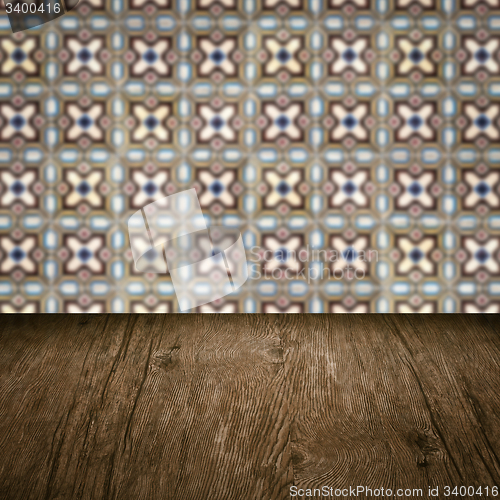 Image of Wood table top and blur vintage ceramic tile pattern wall