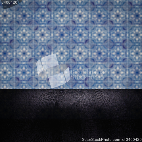 Image of Wood table top and blur vintage ceramic tile pattern wall