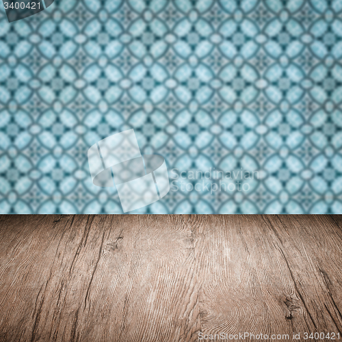 Image of Wood table top and blur vintage ceramic tile pattern wall