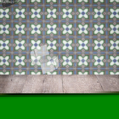 Image of Wood table top and blur vintage ceramic tile pattern wall