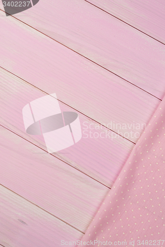 Image of Pink towel over wooden table