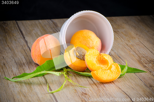 Image of Apricots on wooden table.