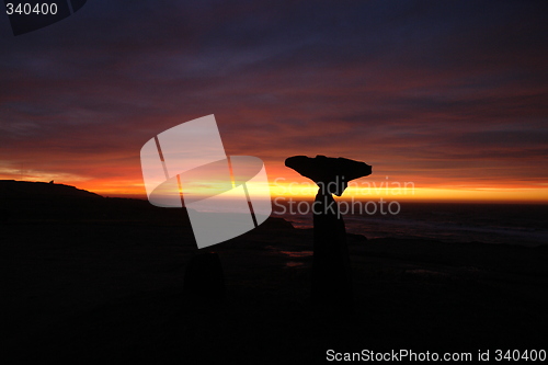 Image of Sunset near beach with stonesculpture