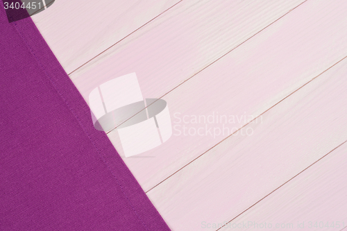 Image of Purple towel over wooden table