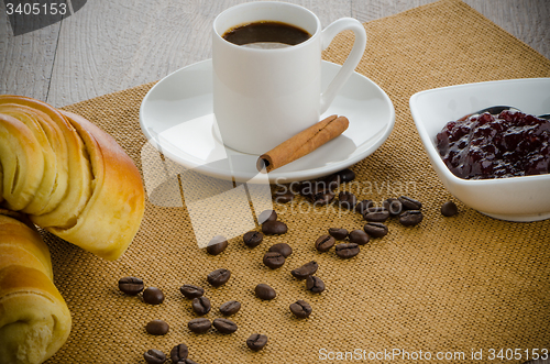 Image of Cup of black coffee and croissant 