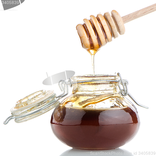 Image of Jar of honey with wooden drizzler