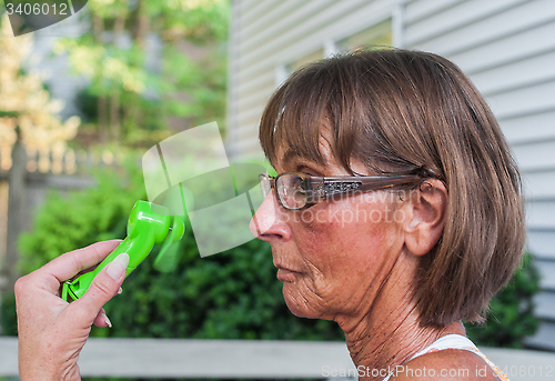 Image of Woman Cools Herself