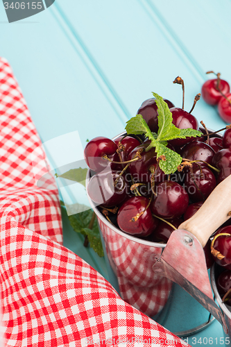 Image of Cherries in blue wooden table