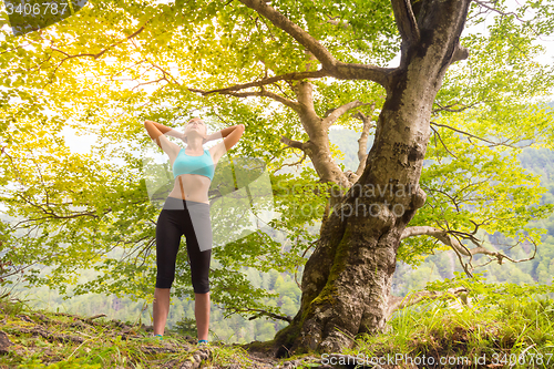 Image of Active sporty woman relaxing in beautiful nature.