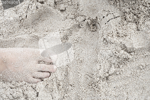 Image of woman feet on the sand