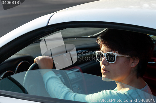 Image of Woman Driving a Sports Car