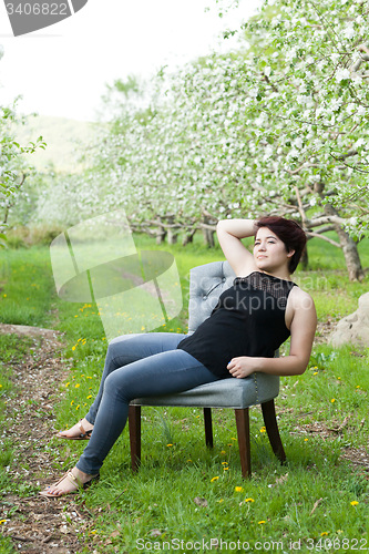 Image of Woman Sitting in a Vintage Chair