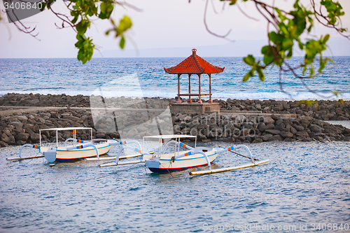 Image of Traditional Boats Anchored off a Stone Jetty in Bali, Indonesia