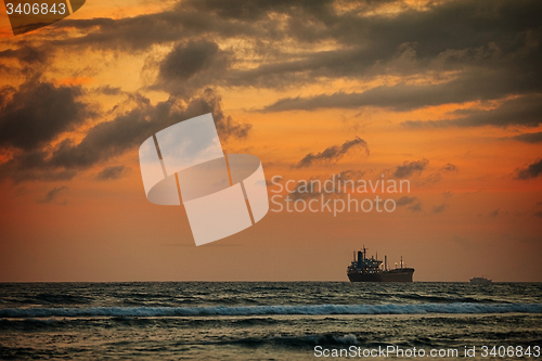 Image of Enormous Tanker Ship on the Horizon at Sunset