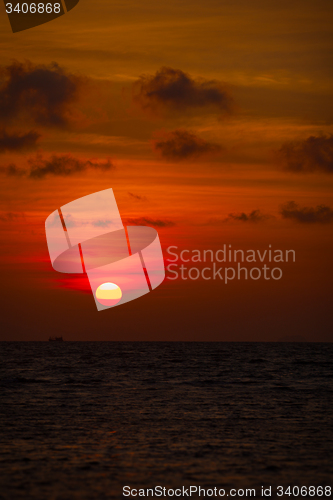 Image of Red Ball of the Sun Descending towards the Horizon at Sunset