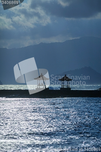 Image of Tourists Resting in the Shelter of a Oceanside Pagoda