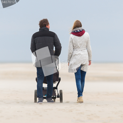 Image of Young couple walking on the beach