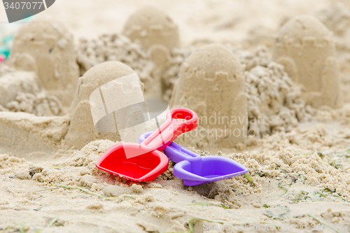 Image of Sand Castle and the shovels and rake