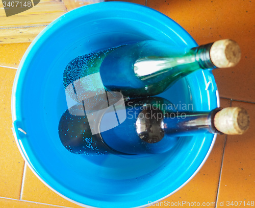 Image of Bottles of wine in cold water