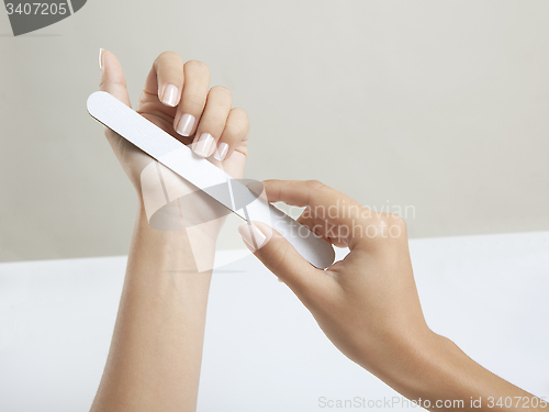 Image of Woman hands with nail file