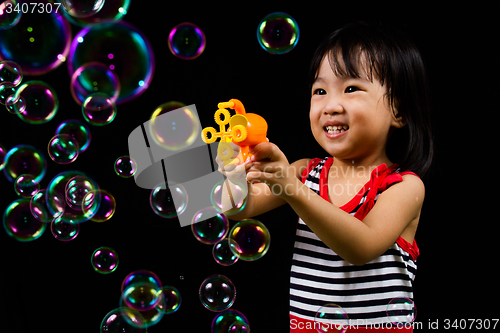 Image of Asian Chinese Little Girl Playing Soap Bubbles