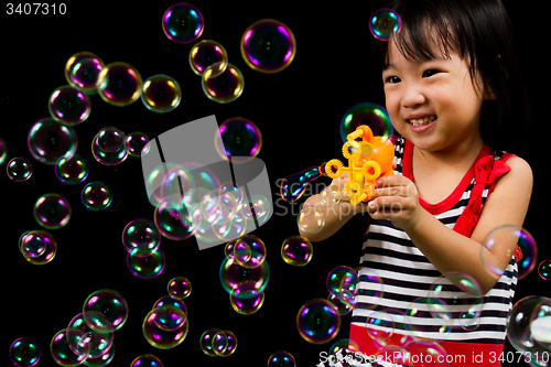 Image of Asian Chinese Little Girl Playing Soap Bubbles